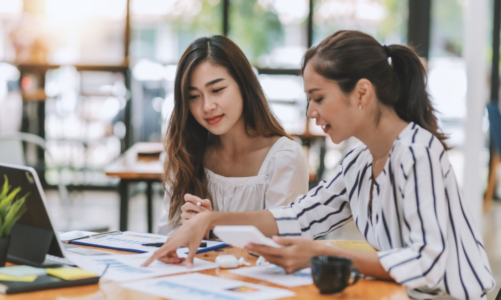 Young Asian female consults with a bancassurance sales executive.