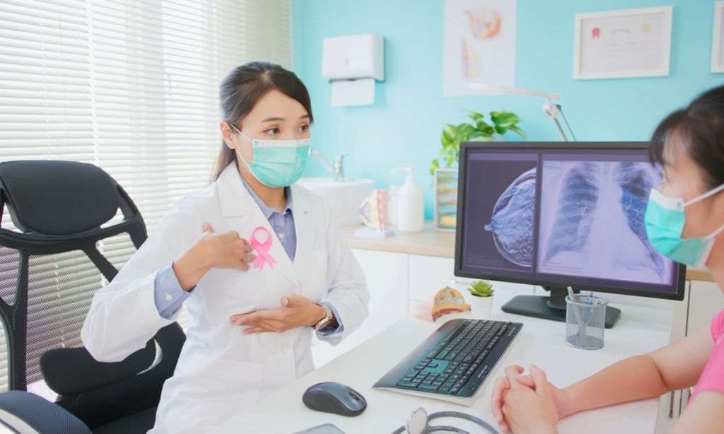 Doctor shows patient how to conduct breast self-exam.