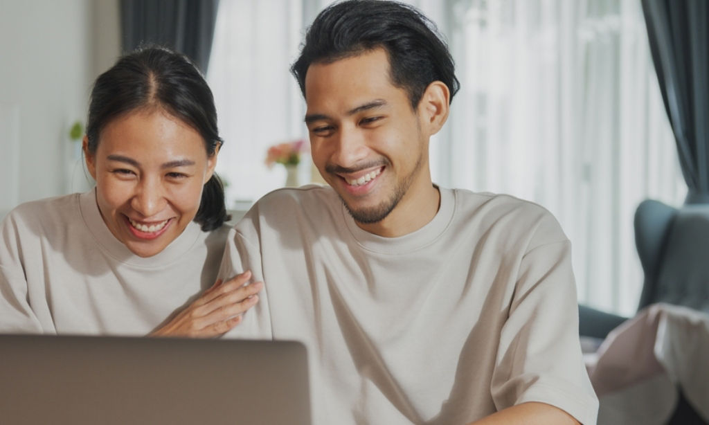 Asian couple and co-breadwinners announce pregnancy over video call.