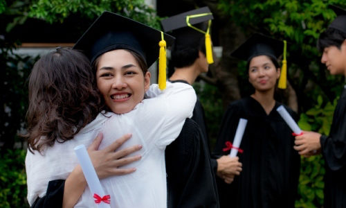 Mother embraces daughter with joy on graduation day