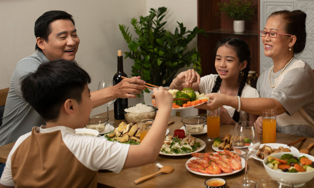 Three females talking and laughing to each other in gym attire.